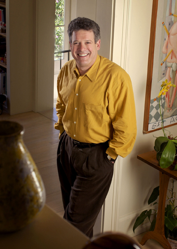 Randy Fertel standing next to a vase.