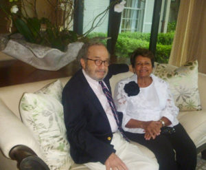 A man and woman sitting on a couch.