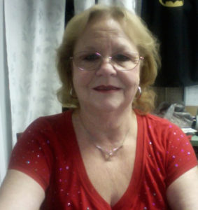 A woman wearing glasses and a red shirt.