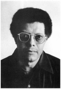 A black and white photo of a man with glasses.